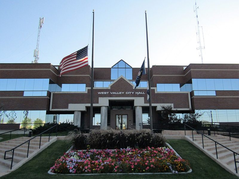 West Valley City Hall entrance with flower beds and flags, West Valley City, Utah